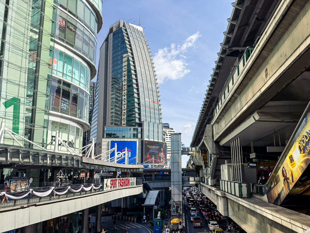 The connection point Between BTS Asoke sky train and Terminal 21 shopping center on a clear afternoon.