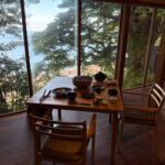 Japanese breakfast served over a grill along with the view overlooking the sea at Sea-auberg Shitsumi.