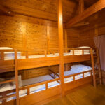 Bunk bed in a wooden cottage at Yunohara Hot Spring Auto Camping Ground.