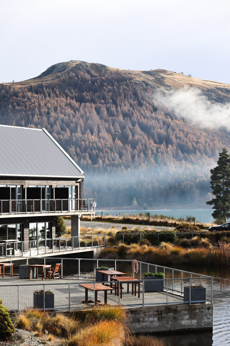 The view from Peppers Bluewater Resort Lake Tekapo in autumn, with a mountain behind partially covered in fog and small cloud