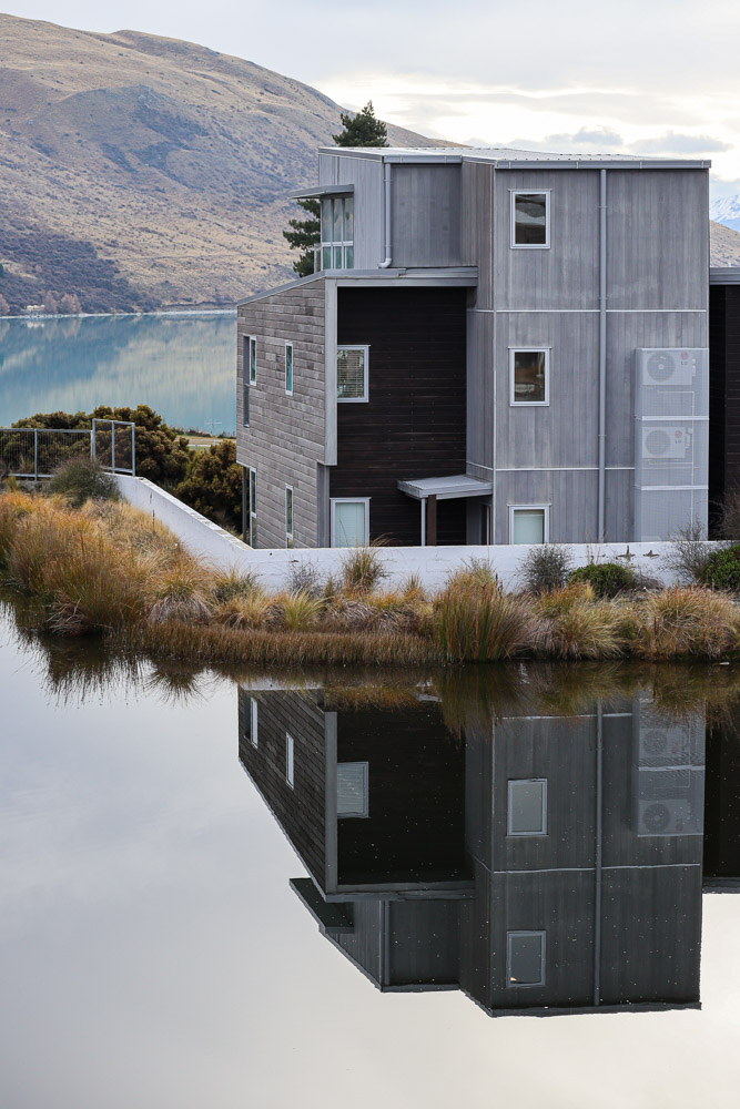 The view from a room at Peppers Bluewater Resort Lake Tekapo in autumn of one of the unit reflecting on a body of water.