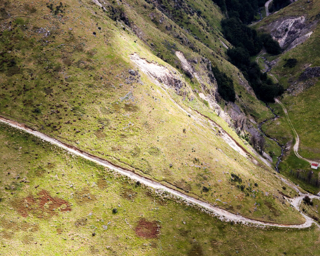 A view of a trail up a mountain in Canterbury from above as light shone on a spot lighting up the path and the grass surrounding it.
