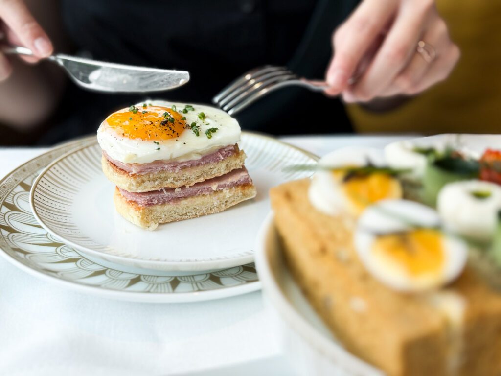 A very well-made, croque monsieur, carefully layered perfectly, with a perfect egg on top.