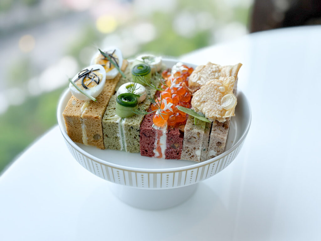 4 styles of sandwhiches, each with its own distinct color theme, carefully plated in an elegant way.