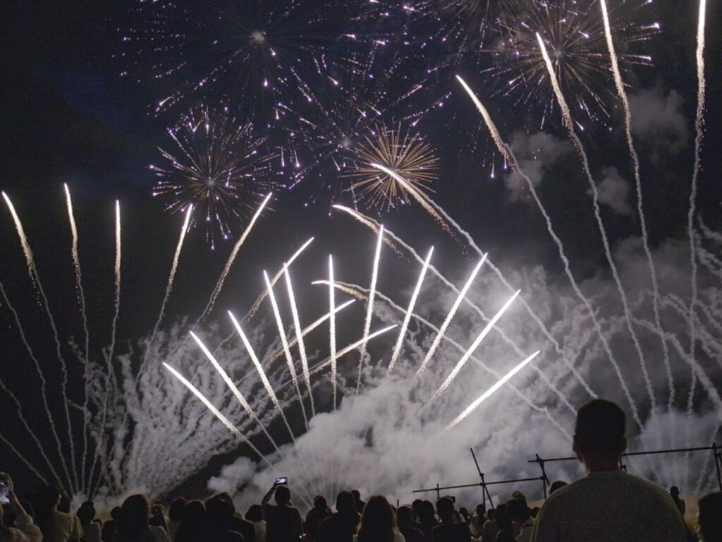 Crowds amazment at the Okinawa waterfront to the Japanese fireworks festival.
