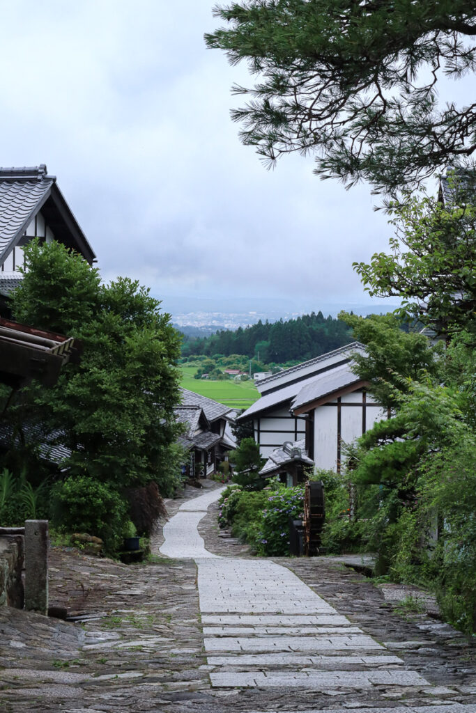 Image of the walkway along Magome-juku in summer, no people, with a view of the field below