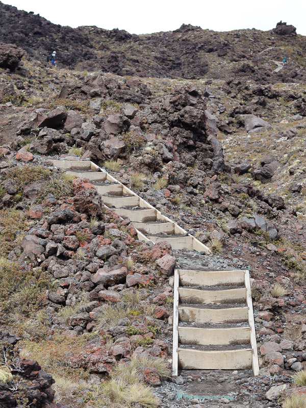 Part of the Devil's Stair case on Tongariro Crossing, the many sections of stairs visible along the mountain in front.