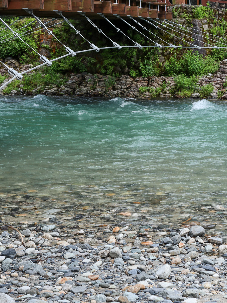 Azusa riverside under the Kappa bridge. A light blue body of water, a source of cold and fresh life in summer of Japan on Kamikochi.