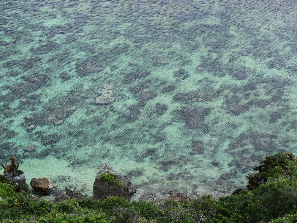 The clear emerald sea water at Ndakachina Beach, Okinawa, a mesmerizing view.