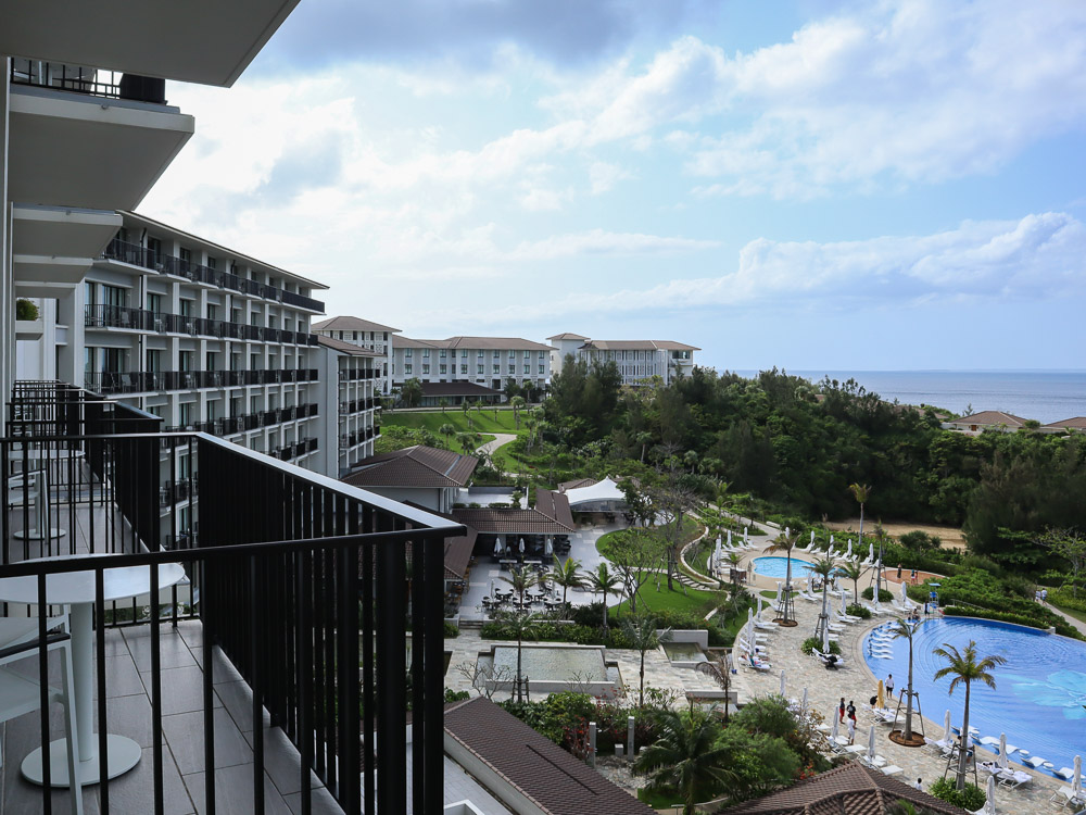 A view from the belcony of a room at Halekulani Okinawa looking out to the resort hotel pool.