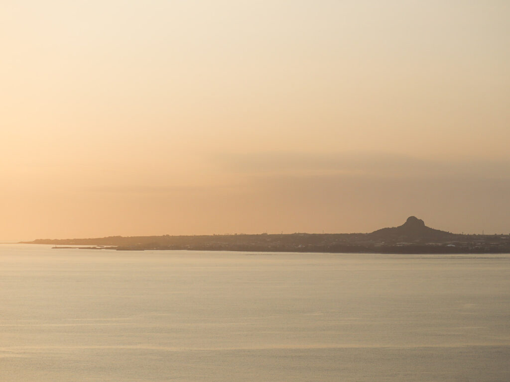 Mount Gusuku on Iejima (Island) off the coast of Okinawa during sunset. An orange hue dyed the sky creating a memorable view.