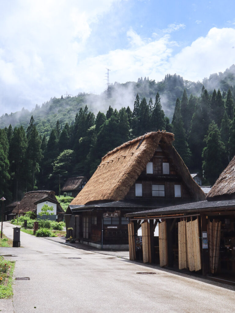 Shop at the entrance of Ainokura Gassho-zukuri Village. Featuring the historical farmhouses, the street empty in summer.