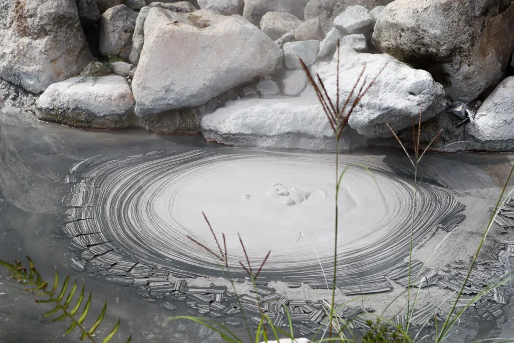 A close up of the hot mud onsen in beppu, a nature wonder of the mud pool bubbling up.