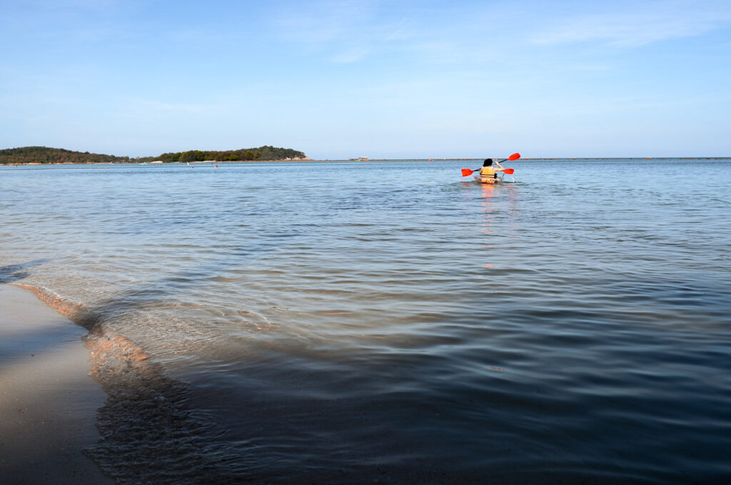 A slow day on Samui in hot summer, kayaking on the Island as afternoon sun shines down and cast a shadow on the sea.