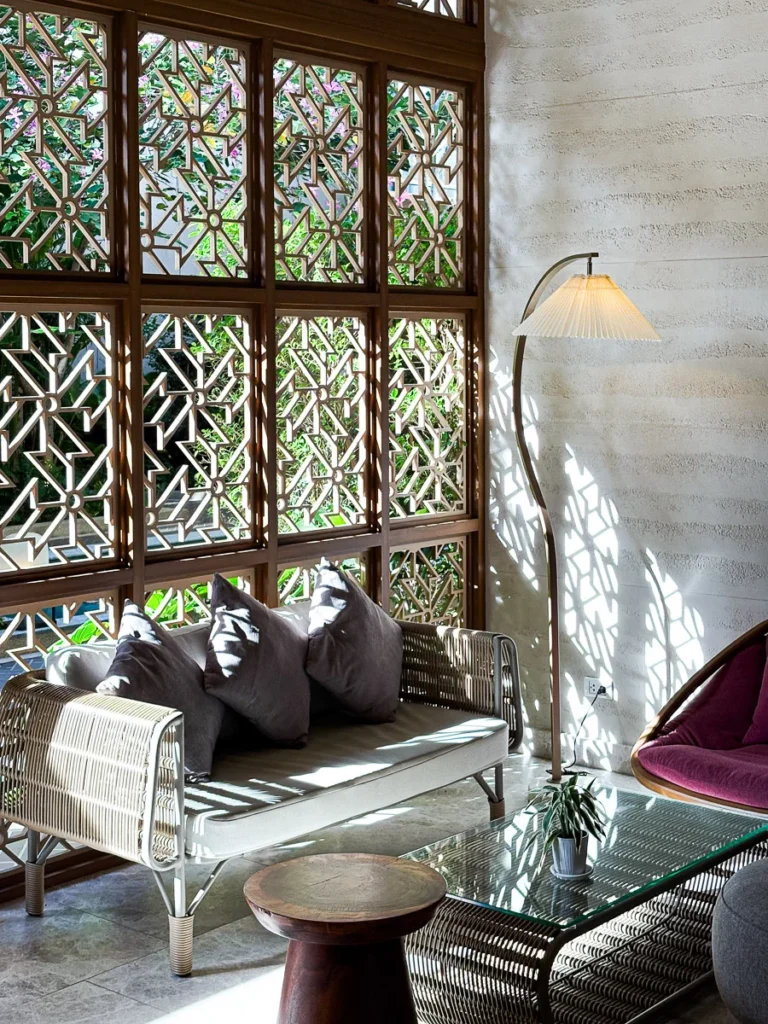 A Photogenic corner as the natural light shines through a patterned facade on to the sofa.