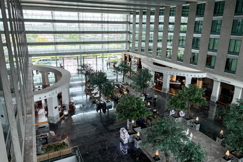 Hyatt Regency Suvarnabhumi lobby and dining area, a 20 years old architechture or guest rooms facing in.