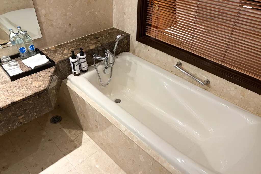 Bathtub clad in marble tiling at Hyatt Regency Suvarnabhumi.