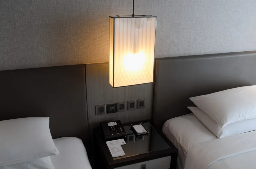The bedside at a guest room in Marriott Marquis Queen's Park hotel. A calming tone perfect for a night's rest.