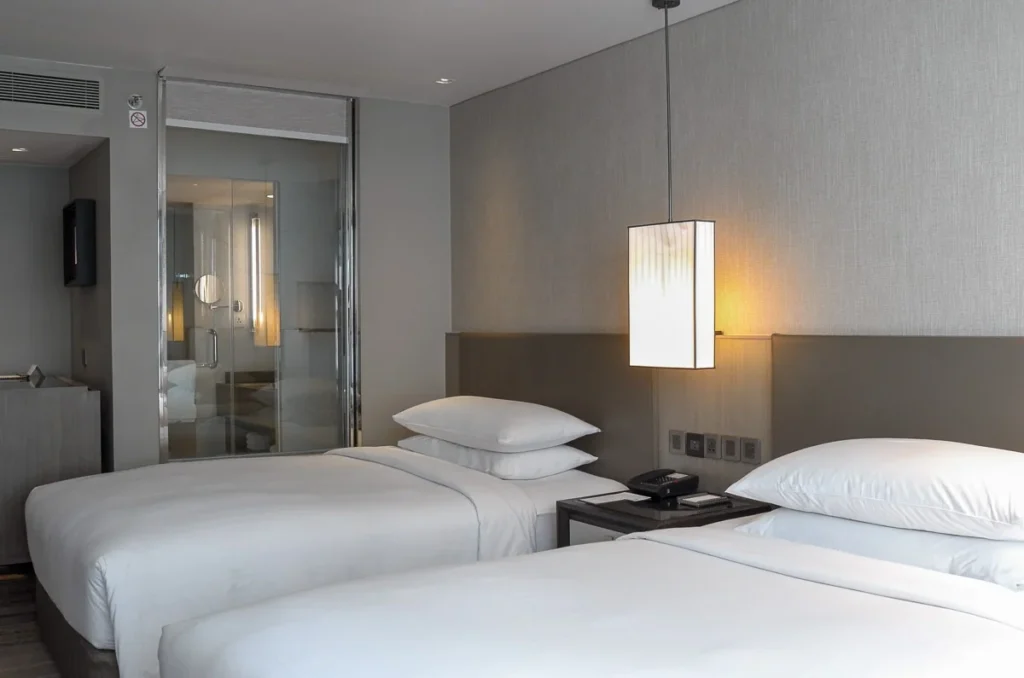 the two beds guest room at Marriott Marquis Queen's Park, a simple, elegant, modern luxurious design.