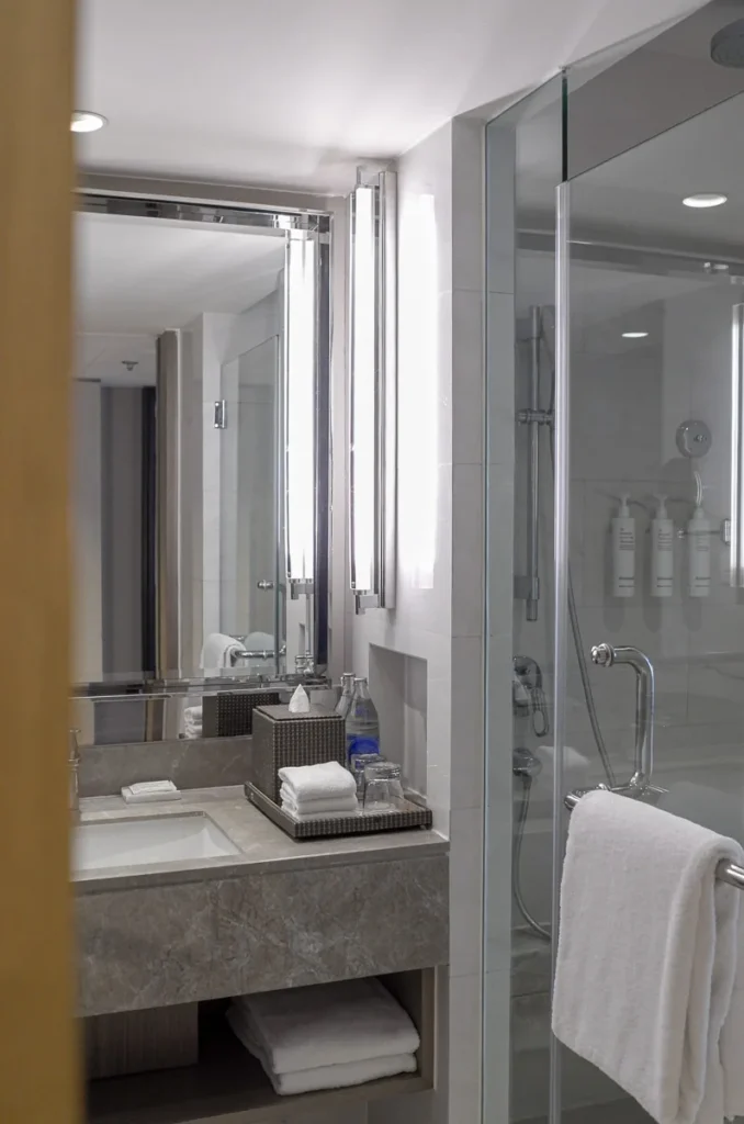 the bathroom at Marriott Marquis Queen's Park standard room type, clean, bright, functional.