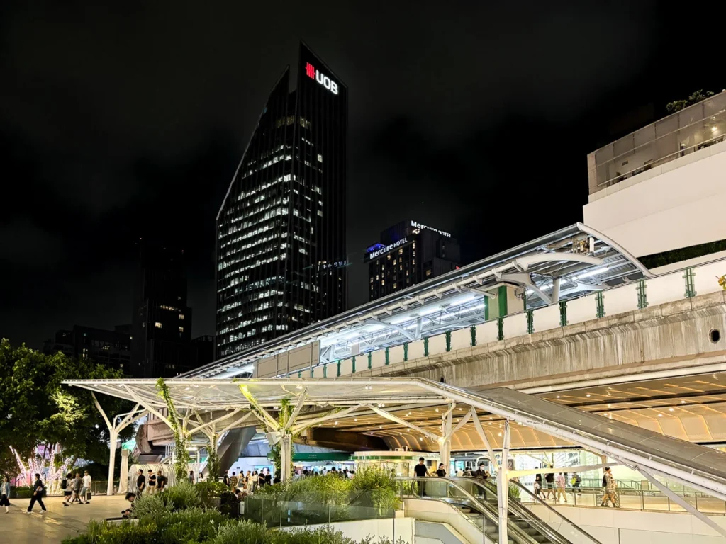 Phrom Phong BTS station at night time, illuminated part of the city center.