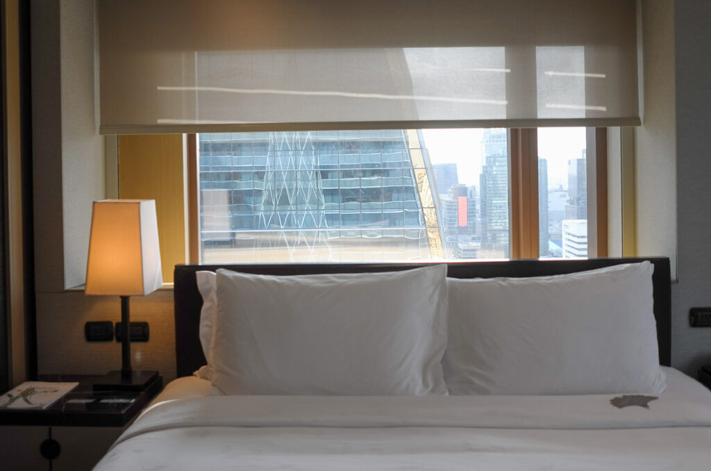 A prime location city view behind the bed at a corner room of Okura Prestige Bangkok Hotel.
