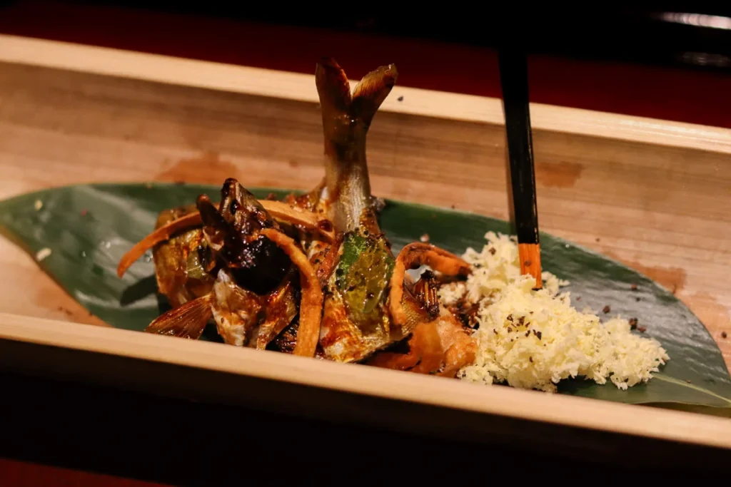 seasonal fish grilled over charcoal and served in a bamboo at TSUKIOKA.