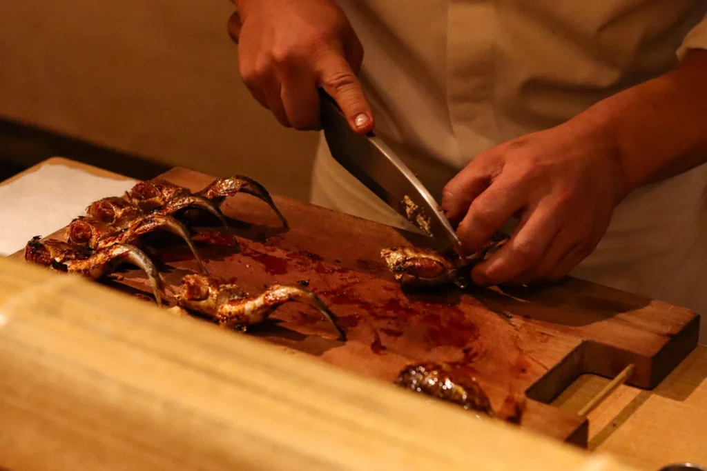 A skewered fish being prepared at Shorenin Monzeki-mae TSUKIOKA.