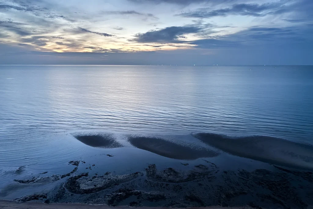 A 6 am sunrise on a cloudy morning at Cha-am Beach, a relaxing and peaceful time.