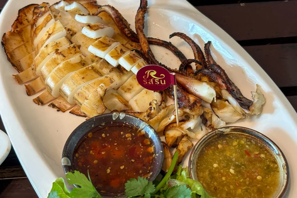 Grilled whole squid with Thai Seafood sauce and sweet and spicy dipping sauce at Rossarin Hua Hin.