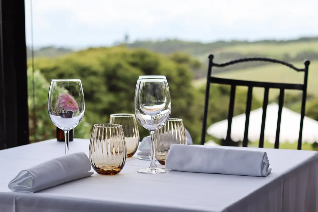A windowside table at Mudbrick Vineyard & Restaurant, a romantic place to dine on Waiheke Island.