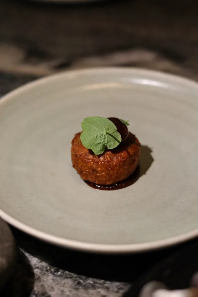 A small bite of carefully crafted pork sholder dish at Rata Restaurant Queenstown, an award-winning restaurant.