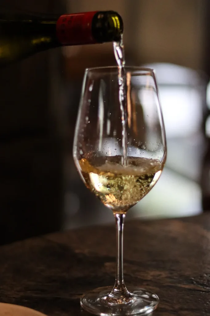 White wine being pored into a glass at Rata Restaurant in Queenstown.