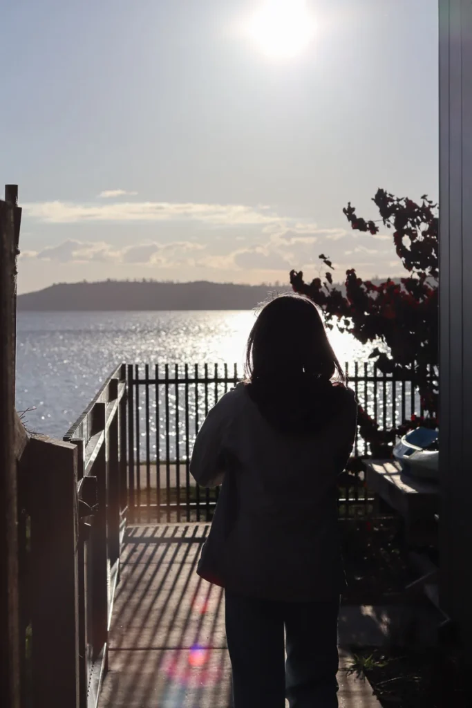 A calming walk on the terrace towards Lake Taupō as the sun shines right into the camera lens.