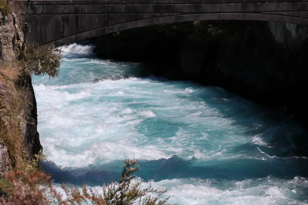 The famous Huka Falls near Lake Taupo, a dramatically flowing rapid water through a small channel.