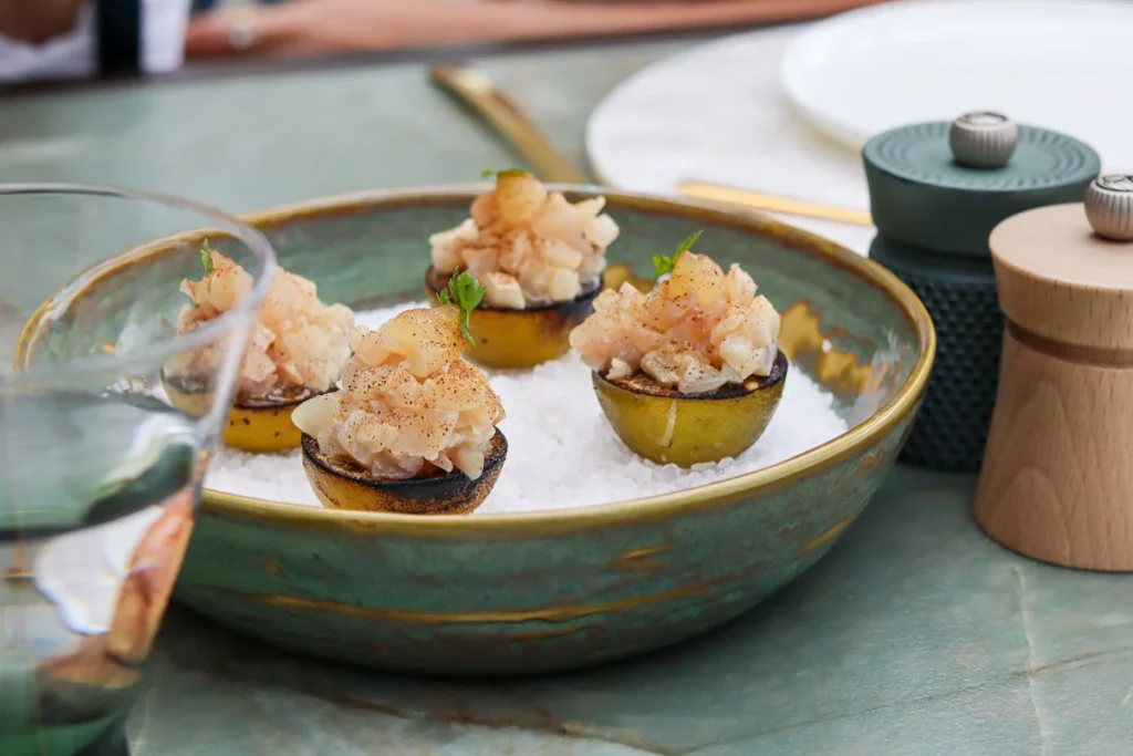 Kingfish ceviche served over burnt lime at The Terrace Restaurant by Roki, a fine dining restaurant.
