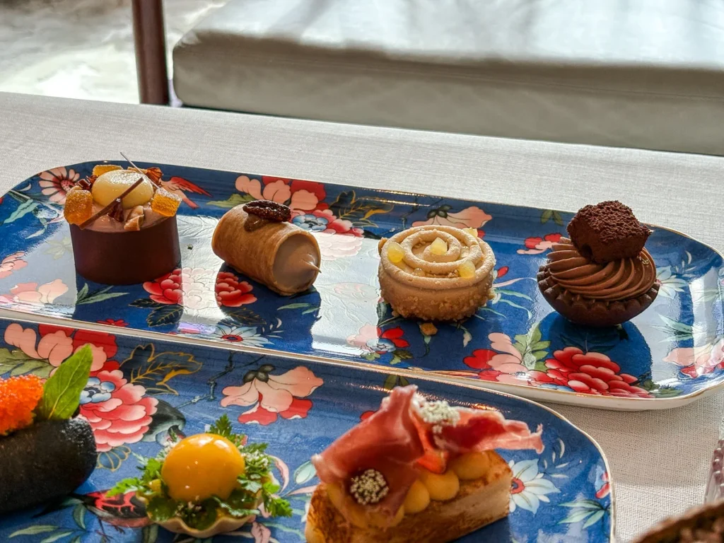 Small, elegantly presented, sweet and savory afternoon tea items at Capella Bangkok.