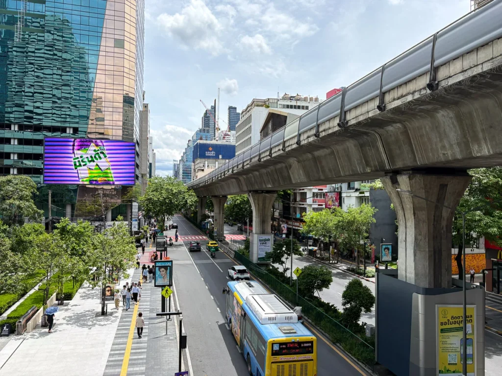 The Silom road illustrating the scale of how big Bangkok feels with sky train rail structure and highrises.