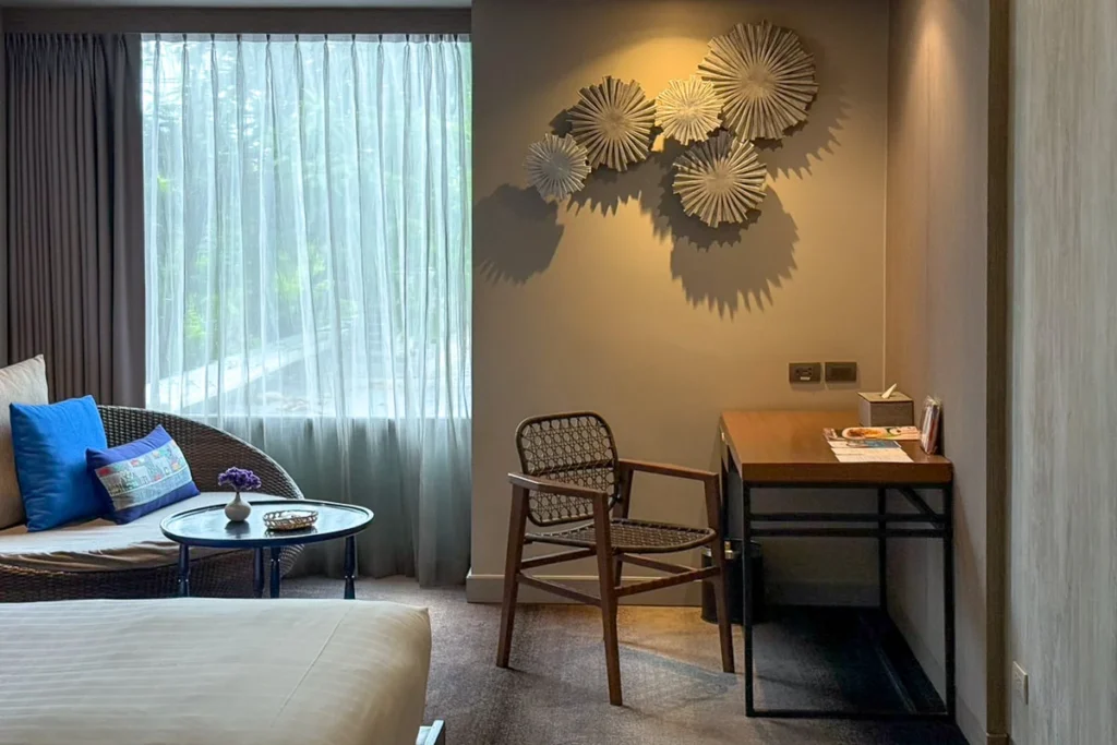 U Nimman Chiang Mai Premium Deluxe Room's working table and couch area with gentle natural light.