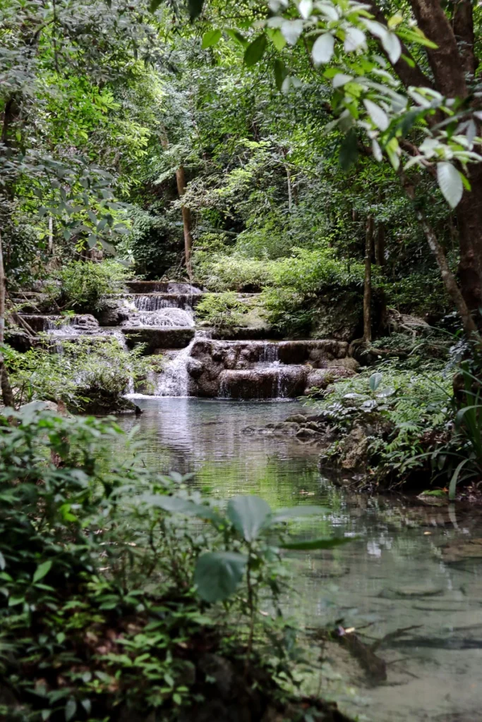 The small waterfalls and the clear stream on Erawan hiking trail.