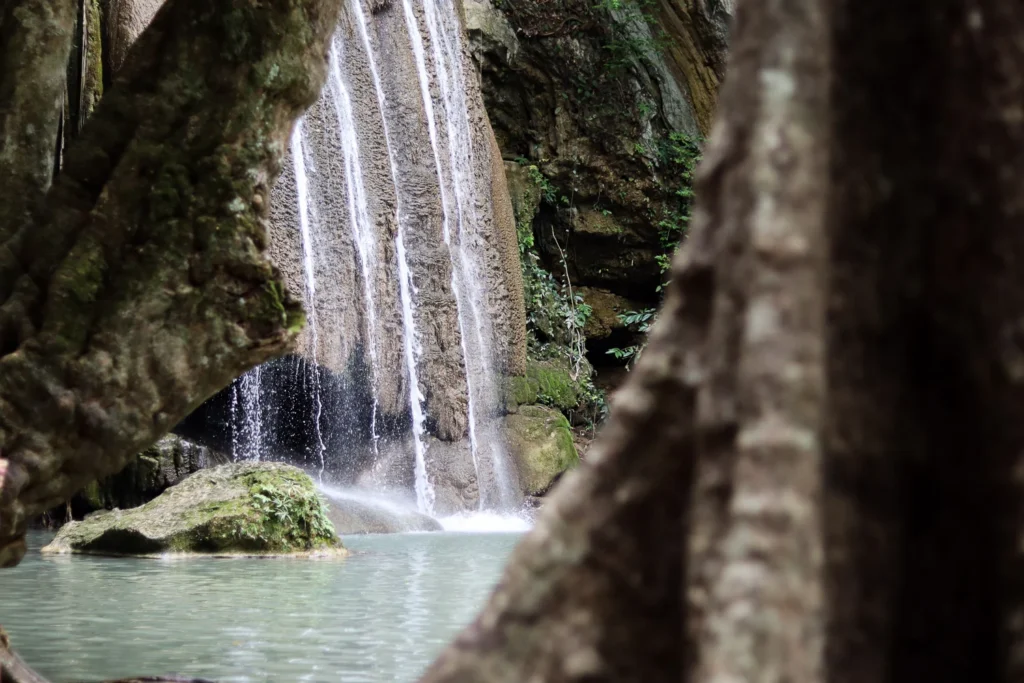 The Third level of Erawan waterfall: a view from behind the big tree.