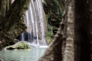 The Third level of Erawan waterfall: a view from behind the big tree.