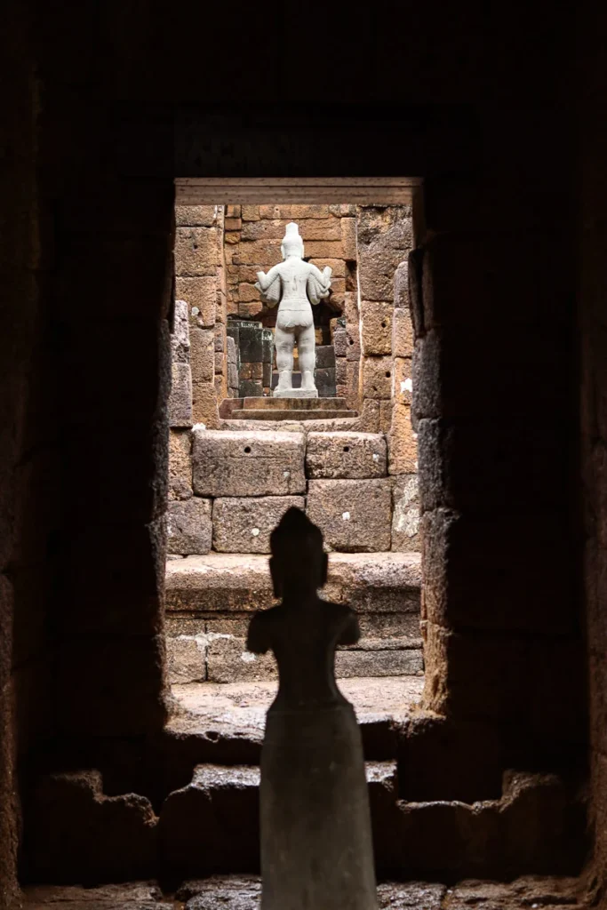 A look through the openings at Mueang Sing Historical Park and the statues inside.