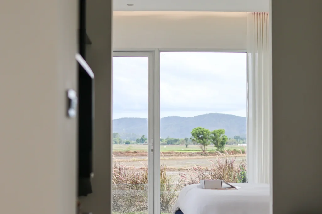 Miti-Tikaan villa, a modern white hotel interior and a view out to the rice field.
